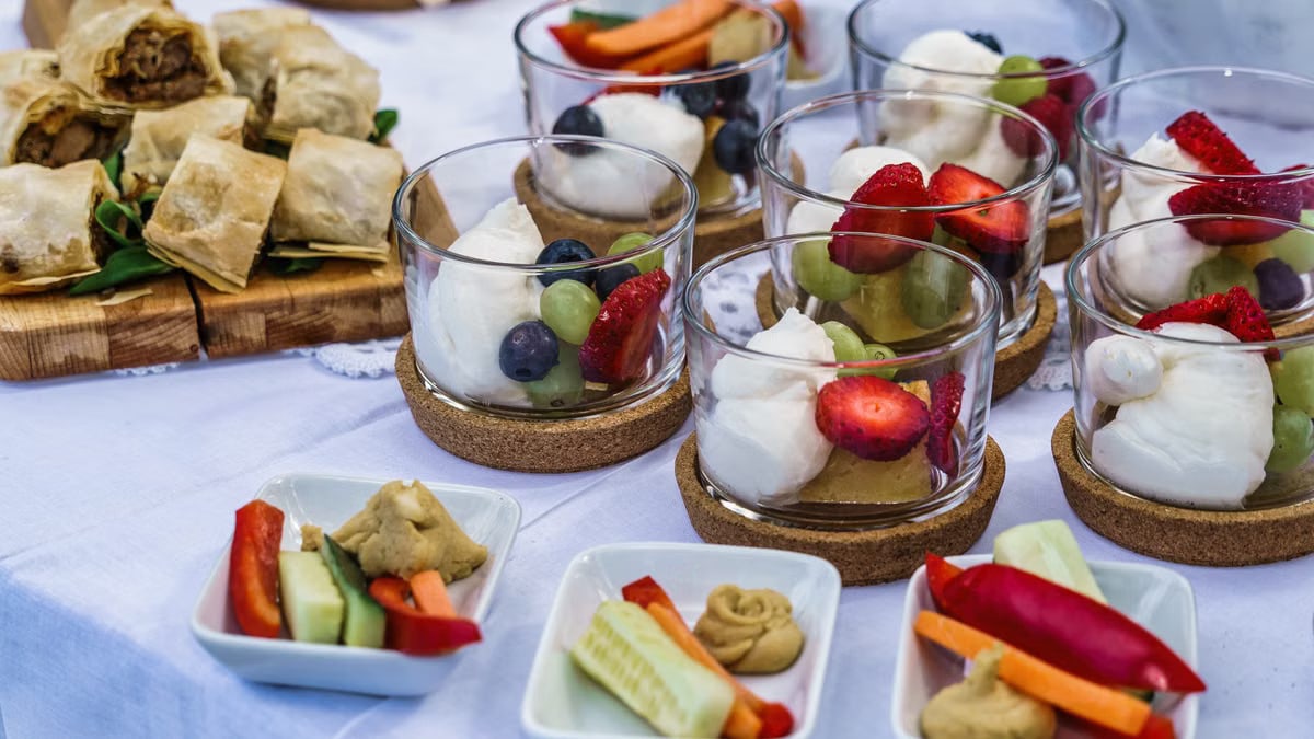Elegant display of desserts and hors d'oeuvres featuring fresh fruits and pastry bites.